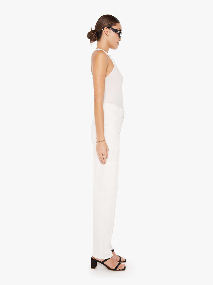 Side view of a womens white cargo pant featuring a super high rise and straight leg.