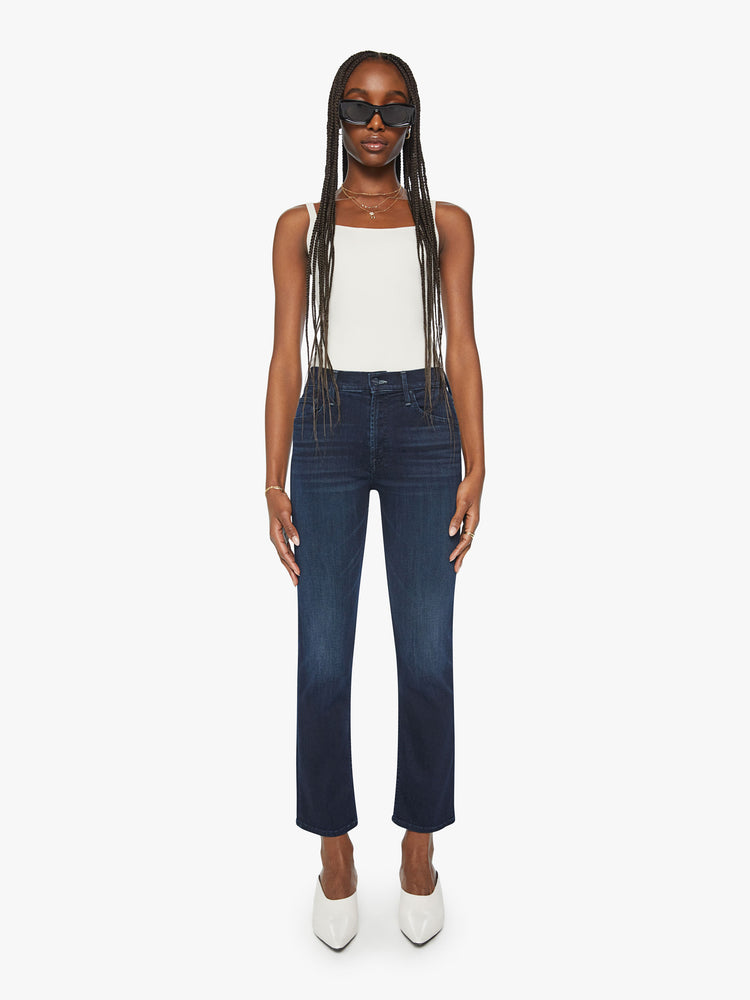 Front view of a woman dark blue mid-rise straight-leg jeans with an ankle-length inseam and a clean hem.