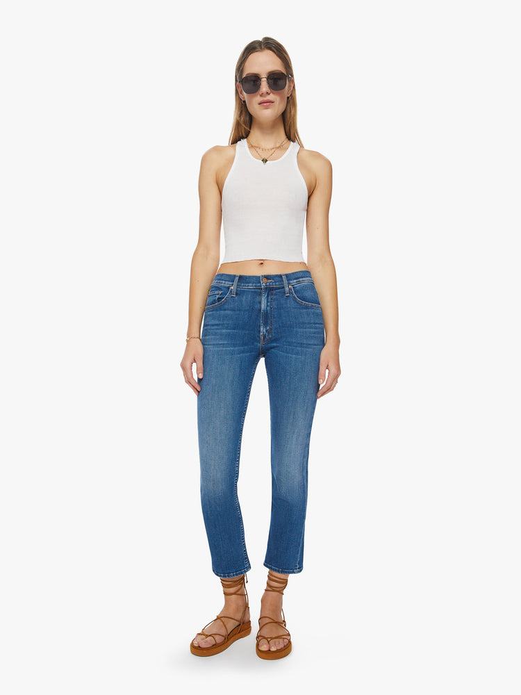 Front view of a woman mid-rise straight-leg jeans with an ankle-length inseam and a clean hem in a mid-blue wash.