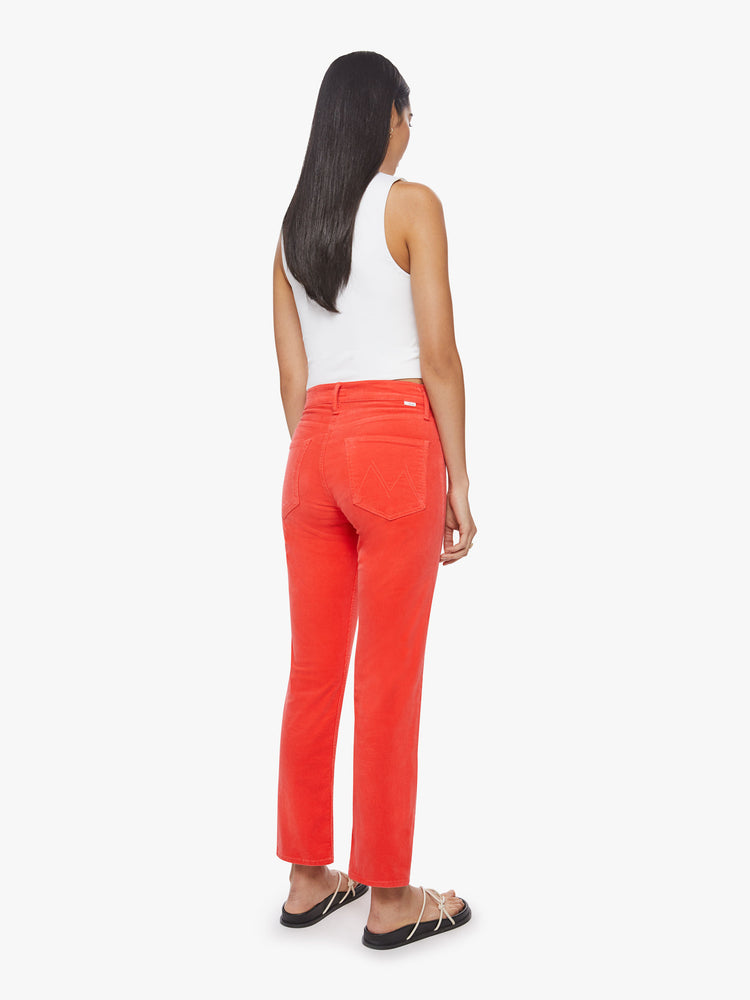 Back view of a woman mid-rise straight leg with an ankle-length inseam and a clean hem in a bright orange-red hue corduroy fabric.
