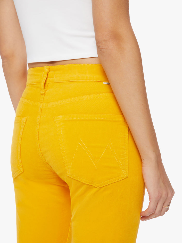 Back close up view of a woman mid-rise straight leg with an ankle-length inseam and a clean hem in a yellow hue corduroy fabric.