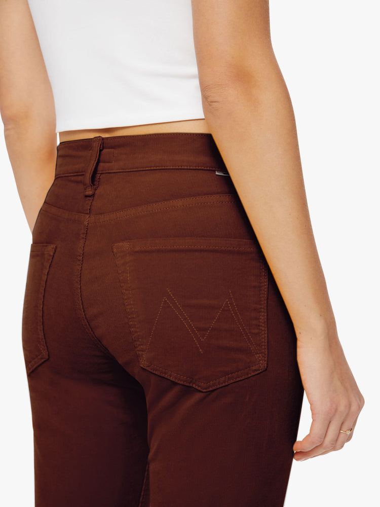 Close up back view of a woman mid-rise straight leg with an ankle-length inseam and a clean hem in a maroon-brown hue.
