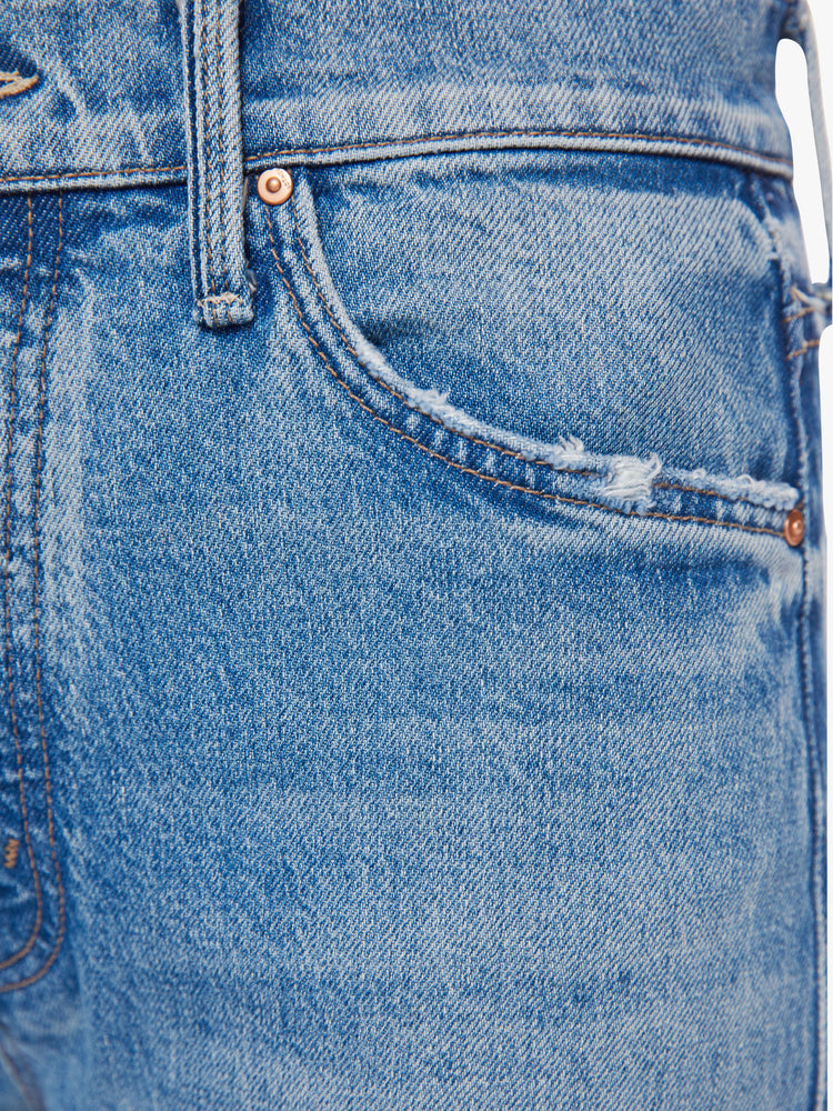 Close up front pocket view of woman wide-leg jeans feature a button fly, low-set back pockets, mid-rise with a slouchy fit and a 32-inch inseam in a vintage blue.