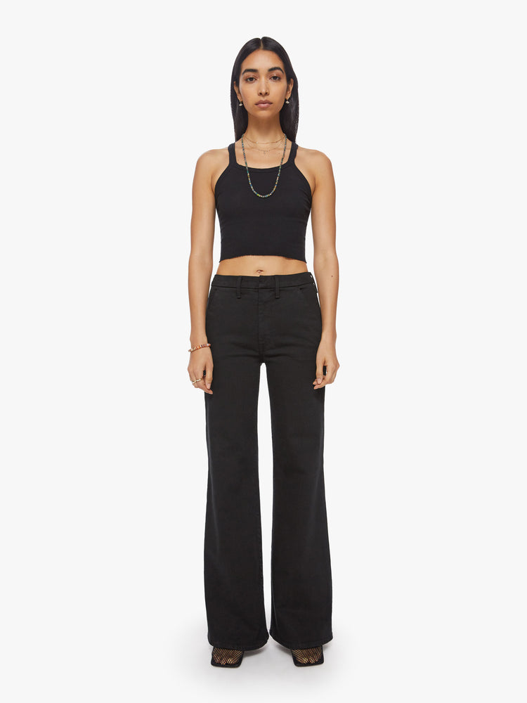 Front view of a woman high-waisted wide leg pant features back slit pockets, a 34-inch inseam and a clean hem in a solid black hue.