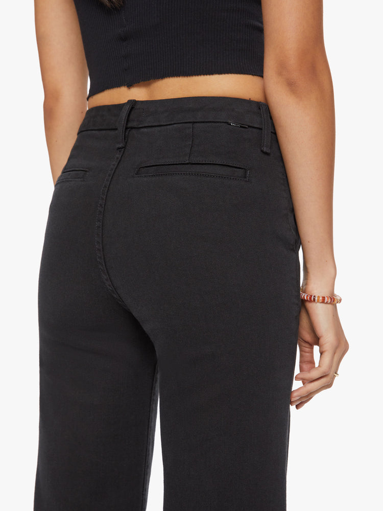 Close up back view of a woman high-waisted wide leg pant features back slit pockets, a 34-inch inseam and a clean hem in a solid black hue.