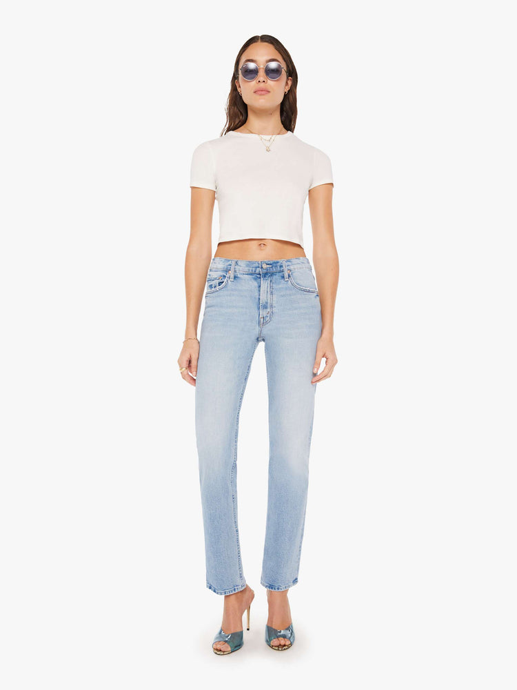 Front view of a woman high-rise jeans with a narrow straight leg and a 31-inch inseam with a clean hem in a light blue wash.