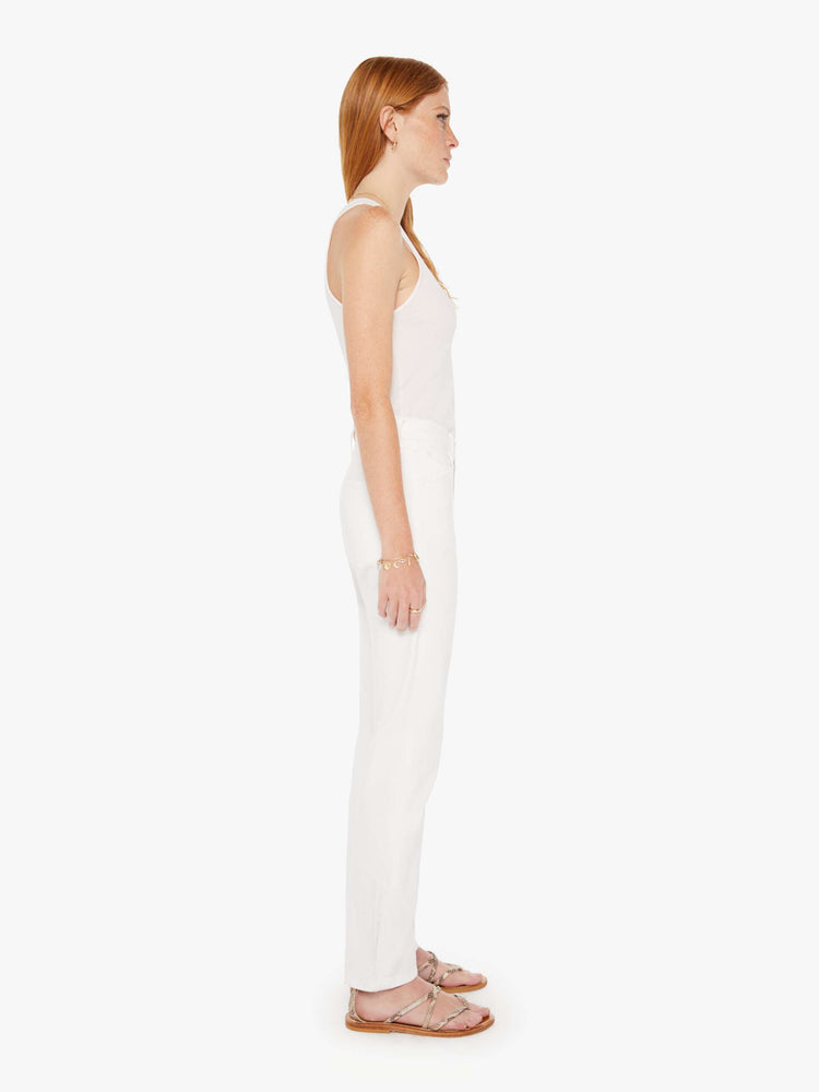 Side view of a womens white denim featuring a high rise and a straight leg.