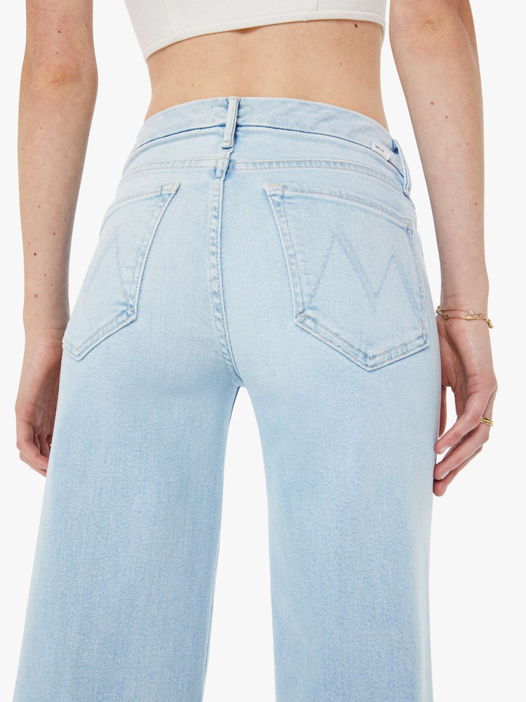 Back close up view of a woman in a wide-leg jeans with a mid rise, 32-inch inseam and a clean hem in a light blue wash.