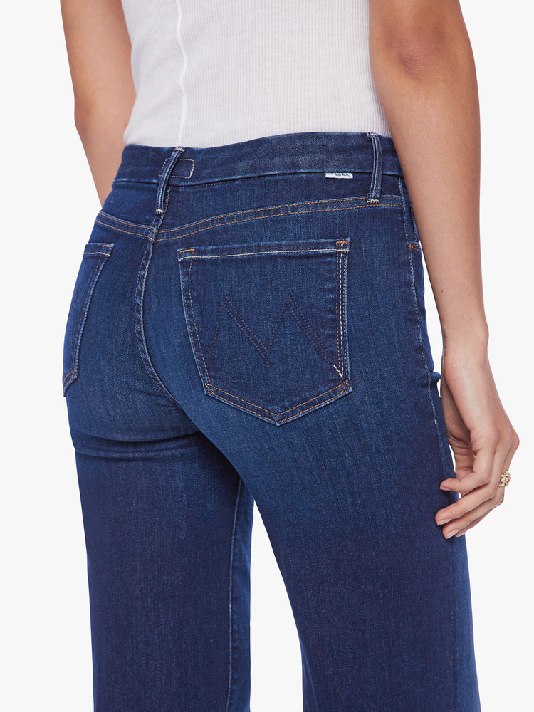 Back close up view of a woman wide leg jeans with a high rise, 32-inch inseam and a clean hem in a dark blue wash.