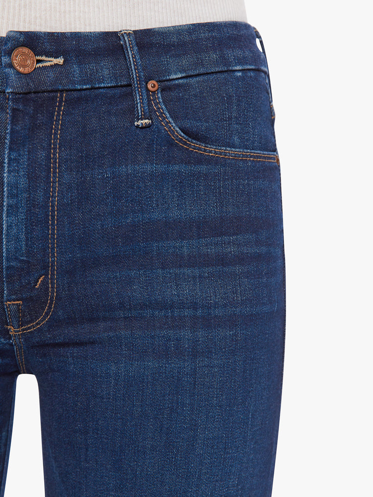 Front close up view of a woman wide leg jeans with a high rise, 32-inch inseam and a clean hem in a dark blue wash.