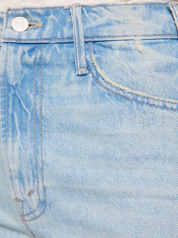 Swatch view of a woman in a light blue  high-rise flare has a zip fly, 28.25-inch inseam and a frayed hem. 