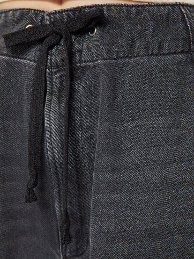 Swatch view of a woman super high-waisted wide-leg jeans feature a drawstring waist, oversized utility pockets and an ankle-length inseam with an elastic drawstring at the hem in a faded black wash.