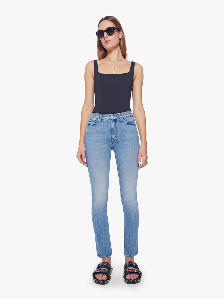 Front view a woman mid-rise straight leg with a 31-inch inseam and a clean hem in a light blue wash.