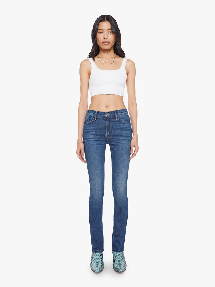 Front view of a woman in a dark mid-rise straight leg jean with a zip fly, long 31-inch inseam and a clean hem.