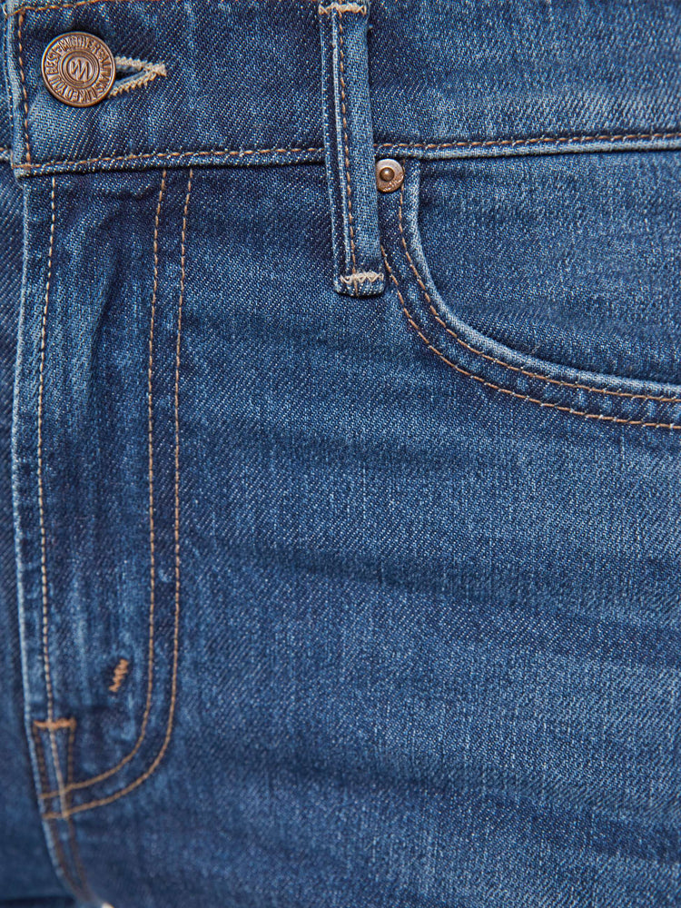 Swatch view of a woman in a dark mid-rise straight leg jean with a zip fly, long 31-inch inseam and a clean hem.