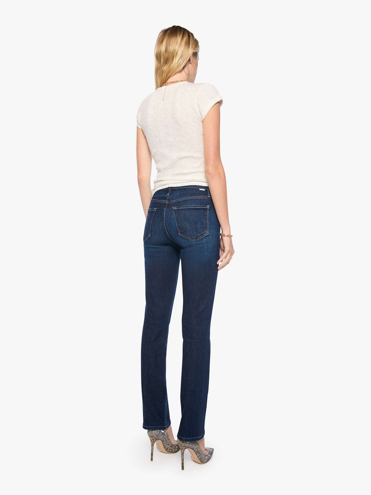 Back view of a woman in dark blue mid-rise straight-leg with a zip fly, long 31-inch inseam and a clean hem.