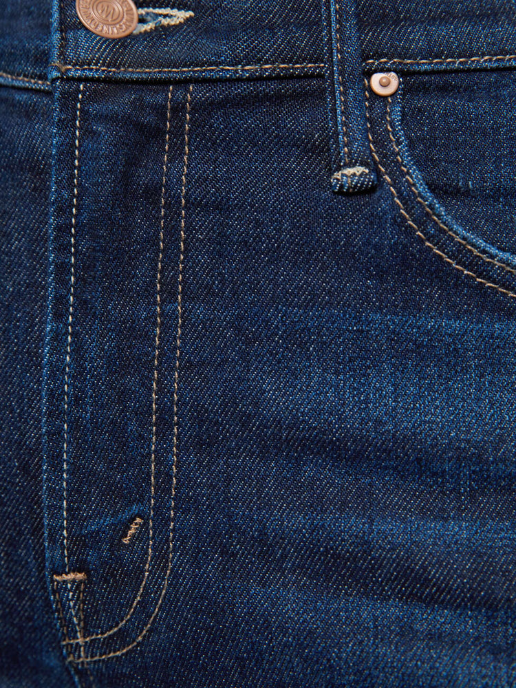 Swatch view of a woman in dark blue mid-rise straight-leg with a zip fly, long 31-inch inseam and a clean hem.