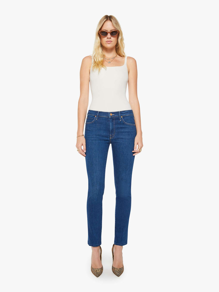 Front view of a woman in a dark blue  mid-rise straight-leg with a zip fly, long 31-inch inseam and a clean hem.