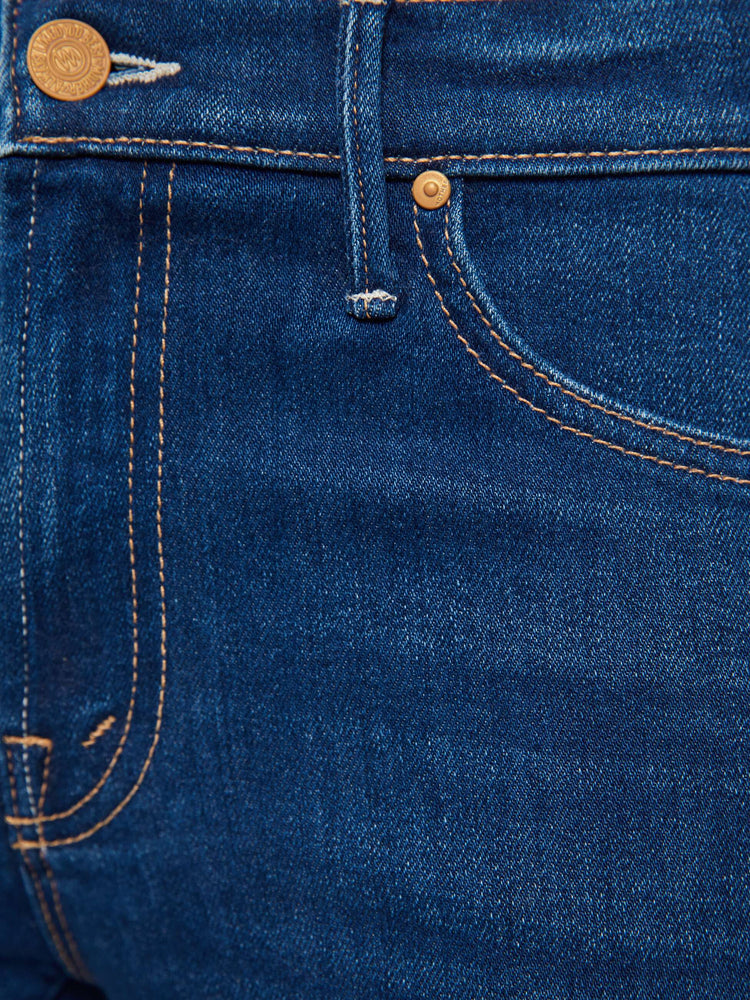 Swatch view of a woman in a dark blue  mid-rise straight-leg with a zip fly, long 31-inch inseam and a clean hem.
