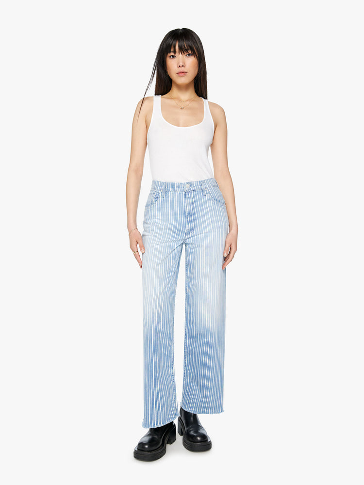 Font view of a woman super high rise jean  with a loose wide leg, zip fly and a 31-inch inseam with a clean hem in a light blue and white striped denim.