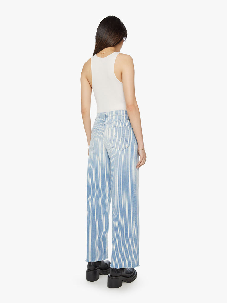 Back view of a woman super high rise jean with a loose wide leg, zip fly and a 31-inch inseam with a clean hem in a light blue and white striped denim.