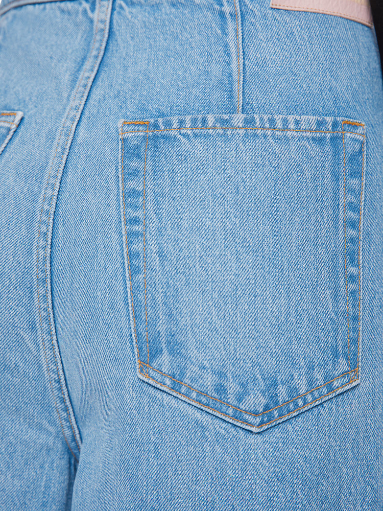 Swatch view of a woman wide leg jean with super high-rise jeans feature a loose, full leg, a wrapped waist that ties in the front and a long 32-inch inseam in a mid blue wash.