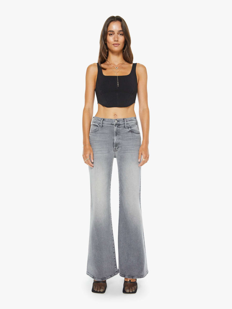 Front view of a woman in grey wide leg pants with a zip fly, high rise, 31-inch inseam and a clean hem.