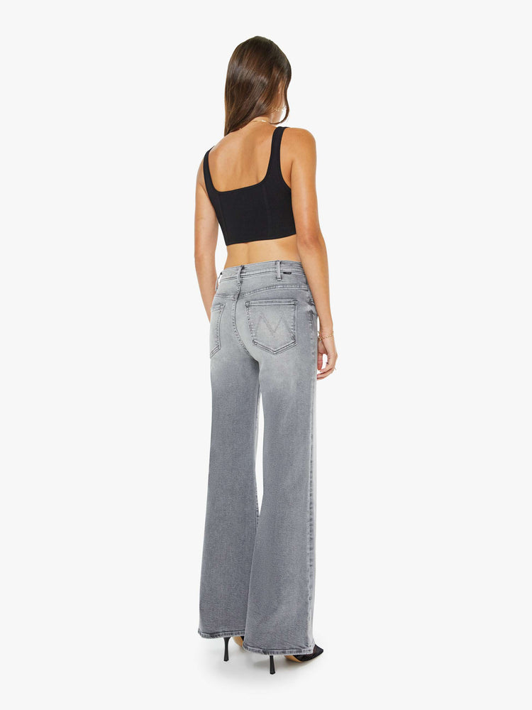 Back view of a woman in grey wide leg pants with a zip fly, high rise, 31-inch inseam and a clean hem.
