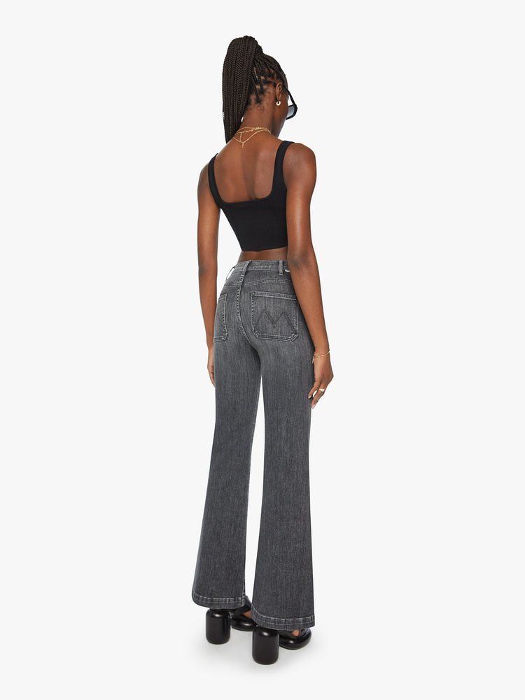 Back view of a woman wide leg jean with a high rise, patch pockets, a 31-inch inseam and a clean hem in a faded black.