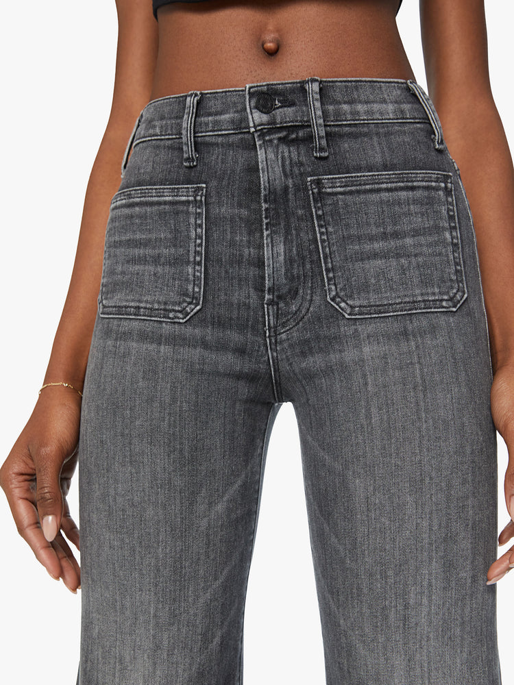 Waist view of a woman wide leg jean with a high rise, patch pockets, a 31-inch inseam and a clean hem in a faded black.