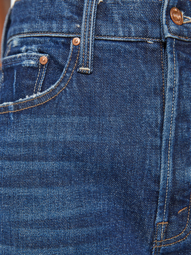 Swatch view of a woman super high-waisted jeans with a straight barrel leg and a cropped inseam with a clean hem in a dark blue wash.