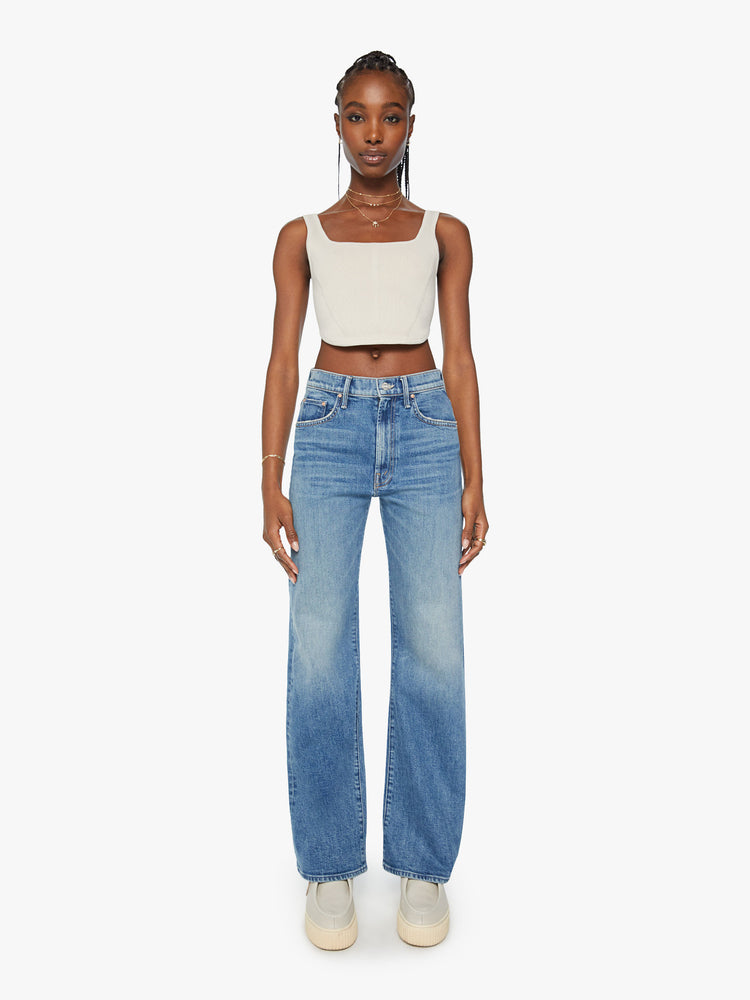 Front view of a woman super wide-leg jeans with a high rise and a long 32-inch inseam in a mid blue wash.
