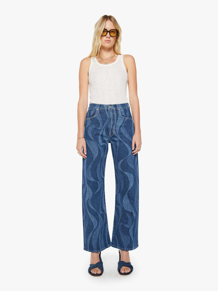 Front view of a woman in a dark blue with a laser-printed abstract stripe pattern wide-leg pants with a zip fly, high rise and a 32-inch inseam with a clean hem. 