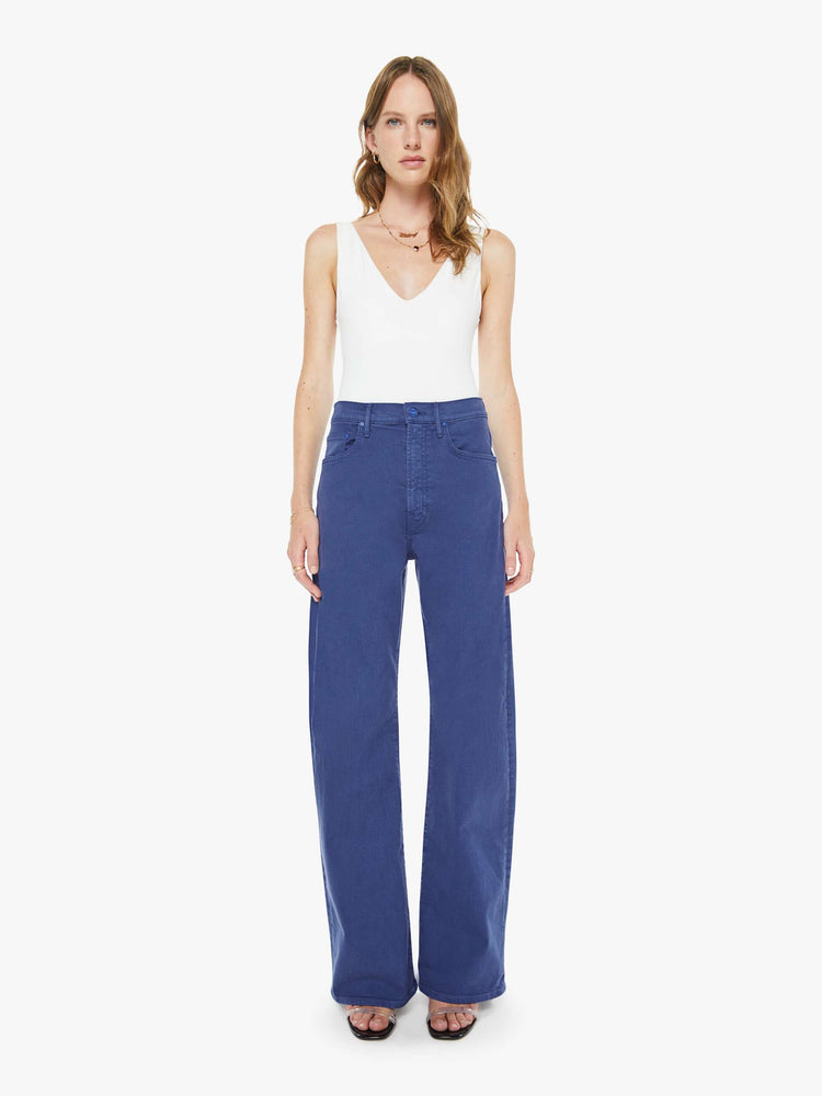 Front view of a woman in navy blue wide-leg pants with a zip fly, high rise and a 32-inch inseam with a clean hem.