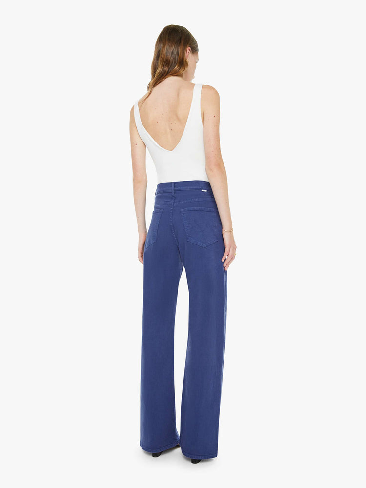 Back view of a woman in navy blue wide-leg pants with a zip fly, high rise and a 32-inch inseam with a clean hem.