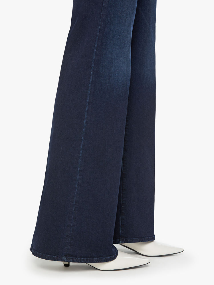 Hem close up view of a woman dark blue wide leg jeans with a high rise, 34-inch inseam and a clean hem.