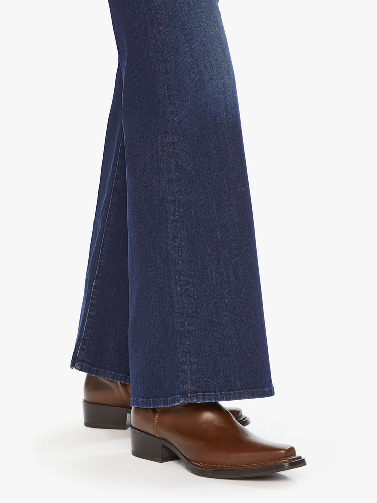 Hem close up view of a woman dark blue wide leg jeans with a high rise, 32-inch inseam and a clean hem.