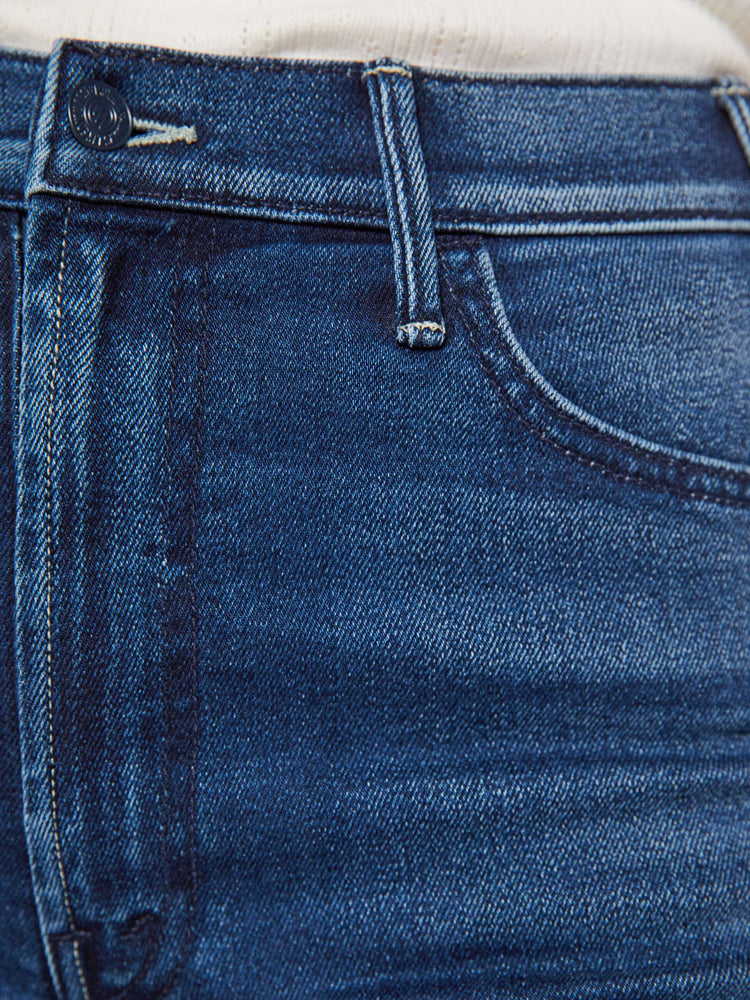 Swatch view of a woman in a dark blue wide leg jean with a high rise, 32-inch inseam and a clean hem.