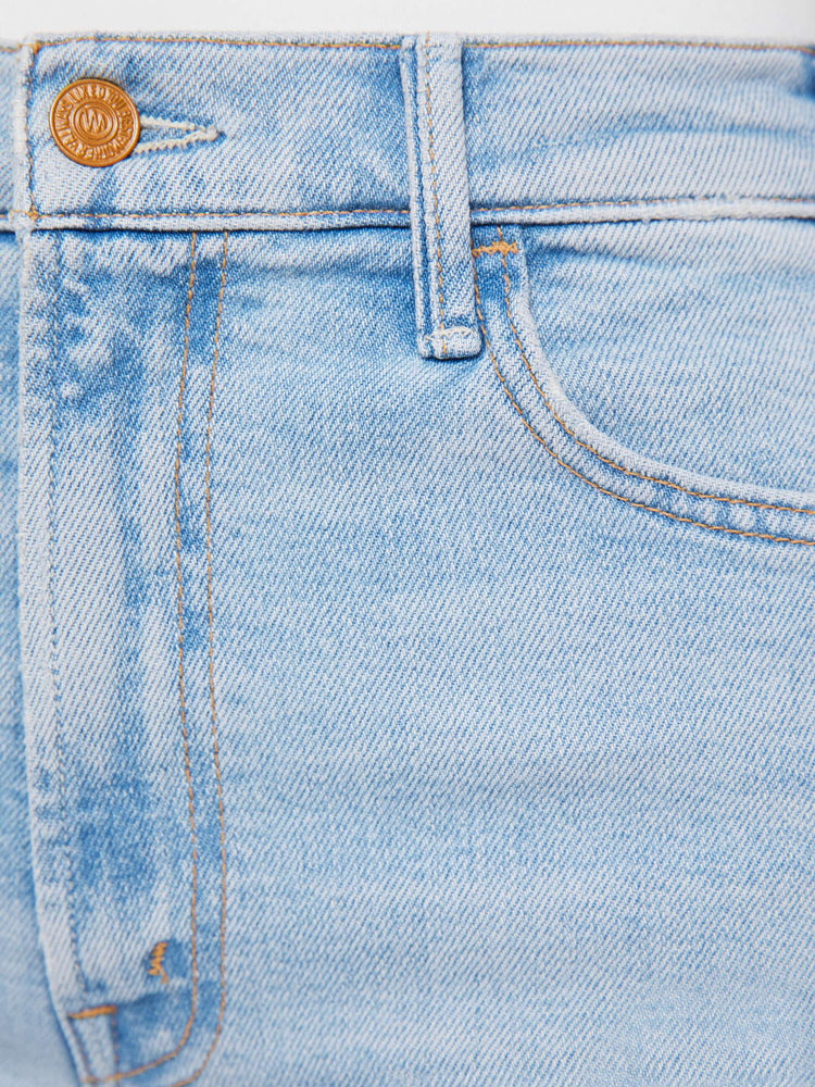 Swatch view of a woman in a light blue wide leg jeans with a high rise, zip fly, 32-inch inseam and a clean hem.