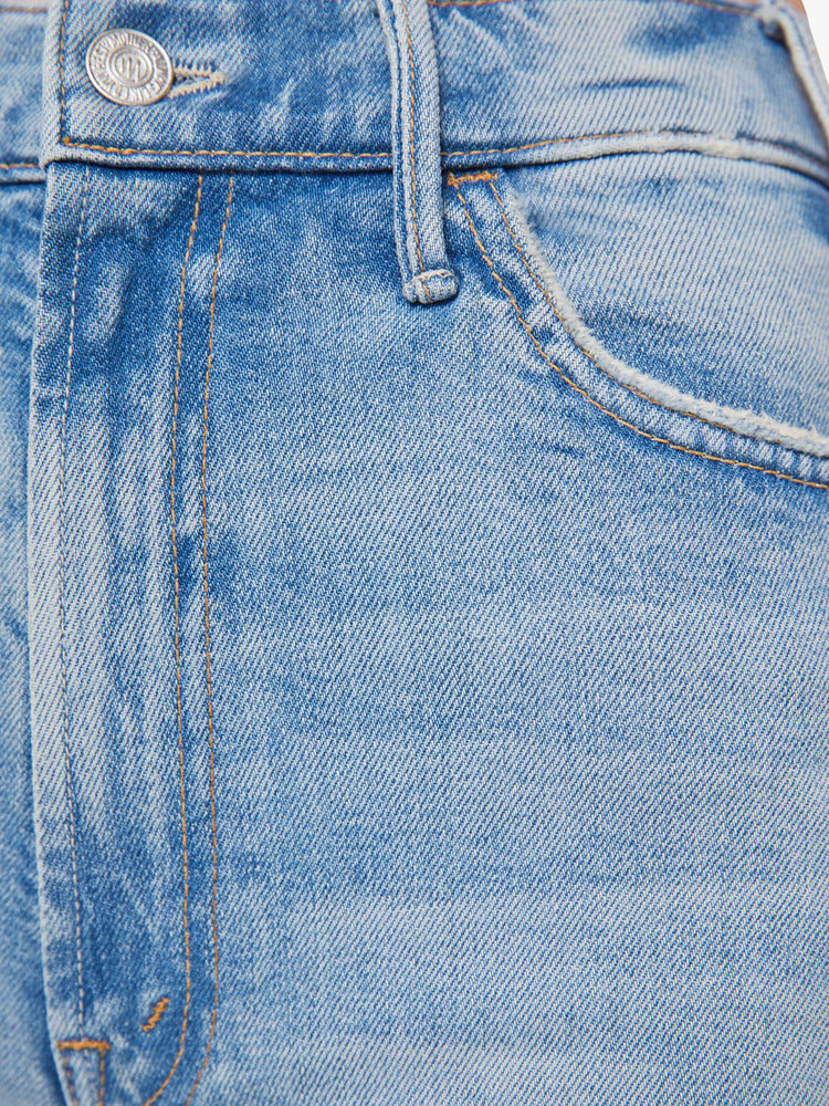 Swatch view of a woman in a light blue wide leg jeans with a high rise, zip fly, 32-inch inseam and a clean hem.