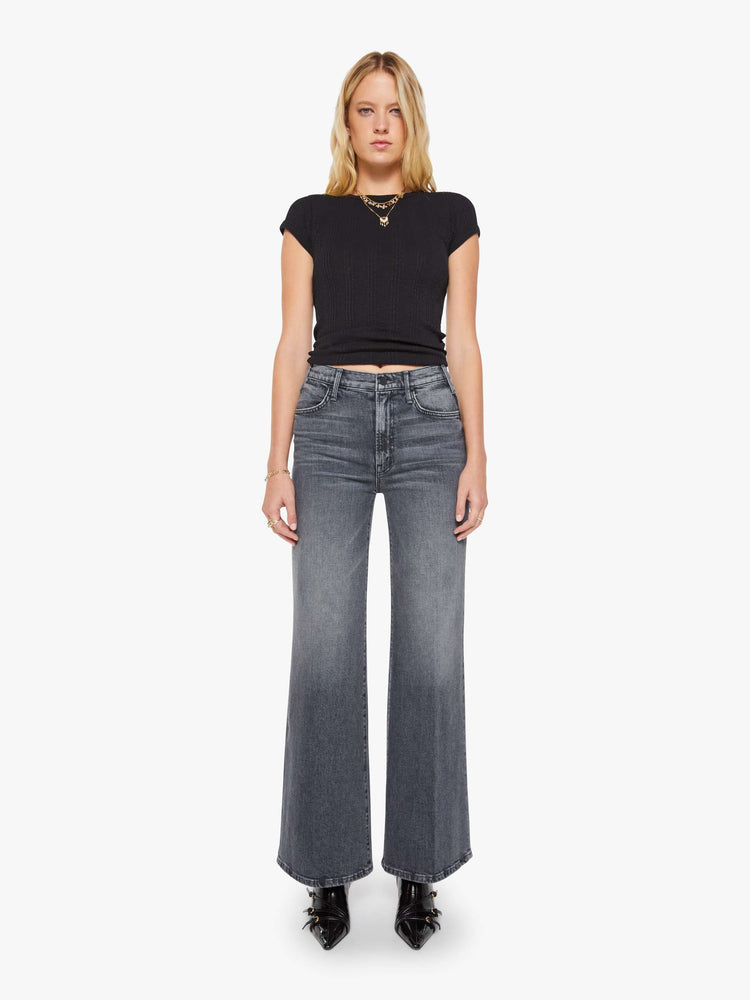 Front view of a woman in faded grey wide leg jeans with a high rise, zip fly, 32-inch inseam and a clean hem.