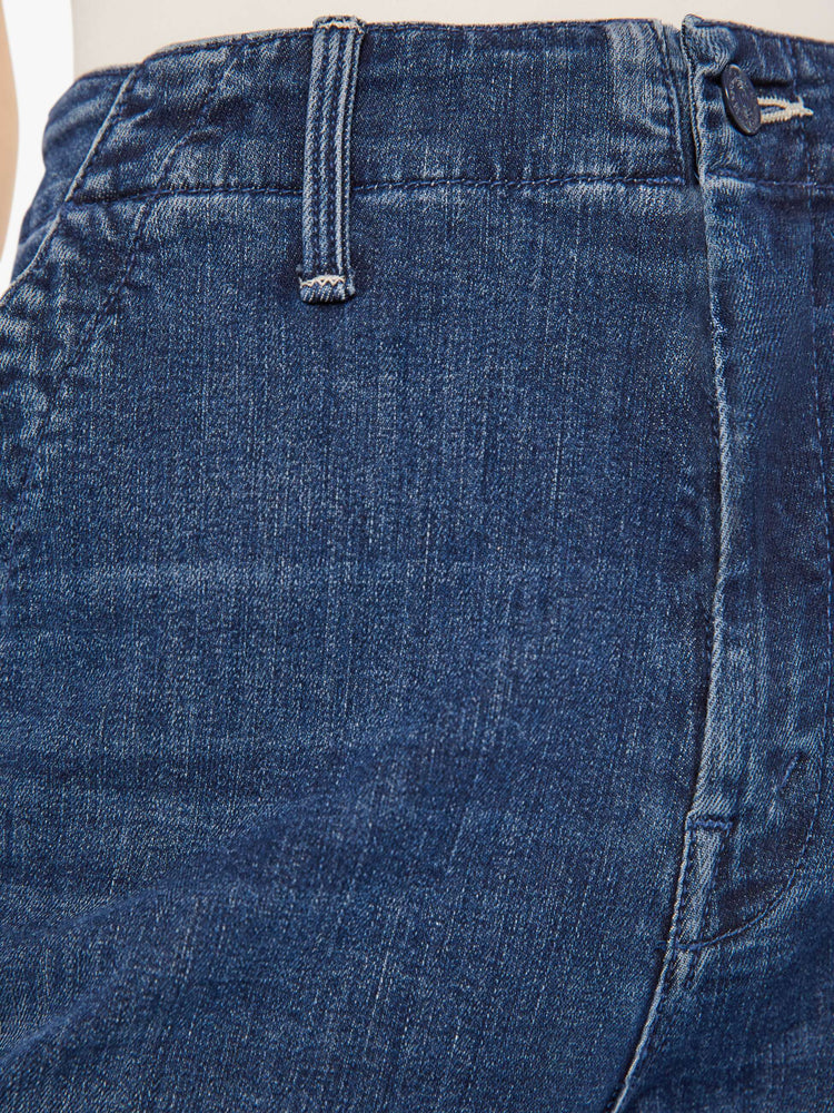 Front close up view of a womens dark blue denim jean featuring a super high rise and wide leg.