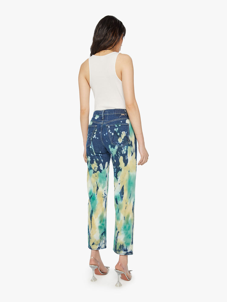 Back view of a woman high rise, straight leg with a clean hem in a dark blue wash with bleached and tie-dyed details in seafoam green and yellow.