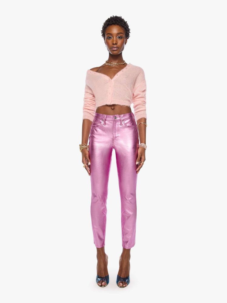Front view of a woman in mid-rise straight leg has a zip fly and a 28.25-inch inseam with a clean hem in a metallic faux leather, Hoop Earrings is a reflective light pink.
