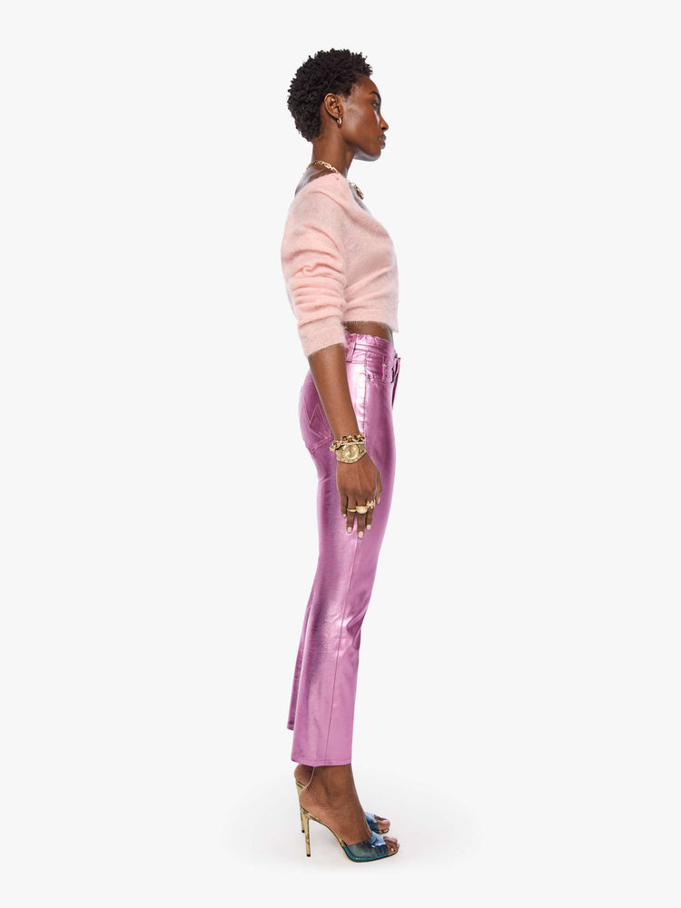 Side view of a woman in mid-rise straight leg has a zip fly and a 28.25-inch inseam with a clean hem in a metallic faux leather, Hoop Earrings is a reflective light pink.