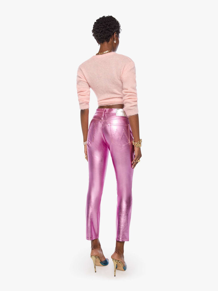Back view of a woman in mid-rise straight leg has a zip fly and a 28.25-inch inseam with a clean hem in a metallic faux leather, Hoop Earrings is a reflective light pink.