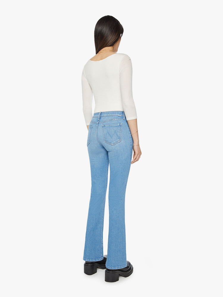 Back view of a narrow flare jeans with a mid rise and a long 32-inch inseam with a clean hem in a light blue wash.