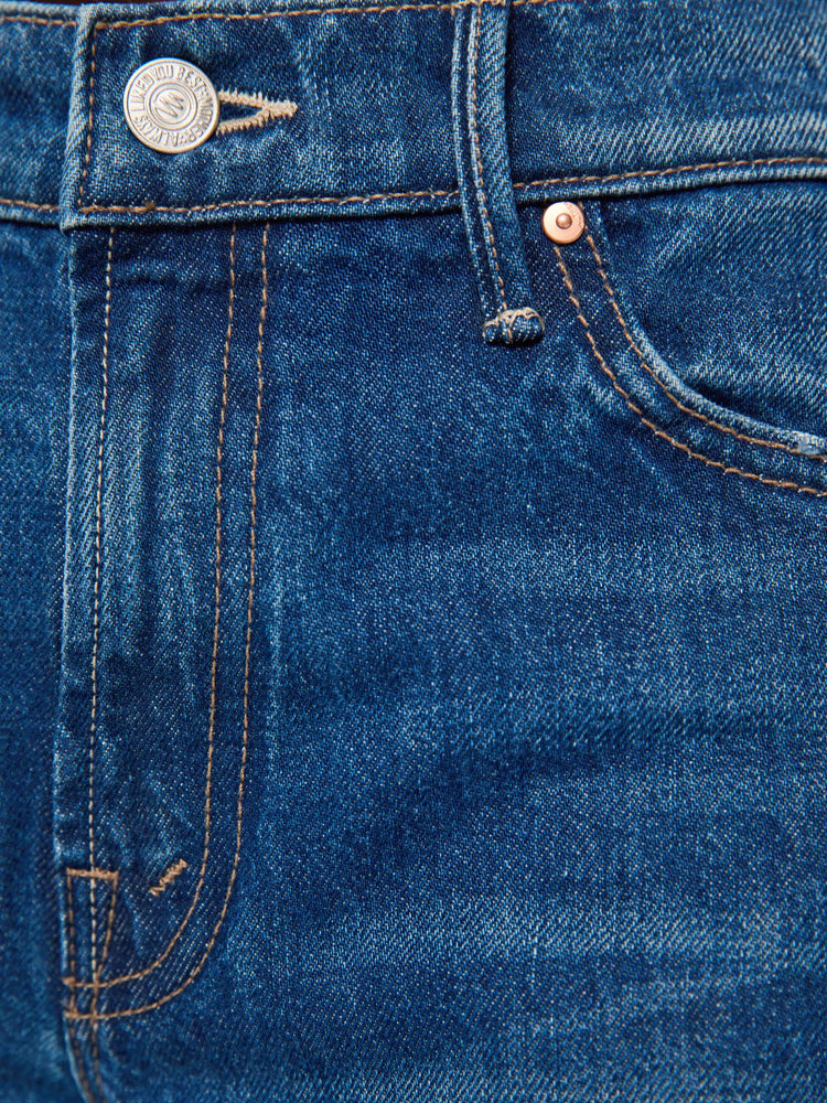 Swatch view of a woman in blue bootcut jeans with a mid rise, zip fly and a long 32-inch inseam with a clean hem.