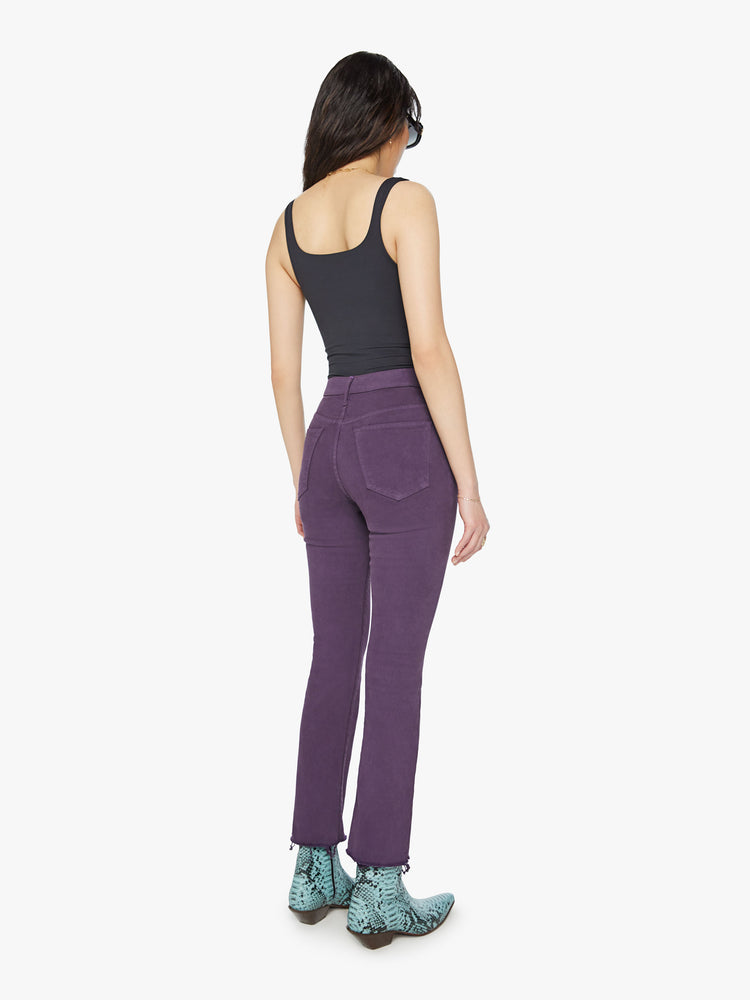 Back  view of a woman high-rise straight leg with an ankle-length inseam and a frayed hem in a blackberry-purple hue.