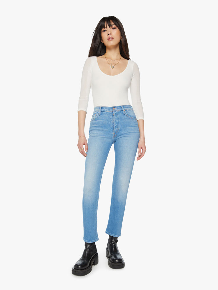 Front view of a woman high rise jean with a straight leg, button fly and a 28.25-inch inseam with a clean hem in light blue wash.
